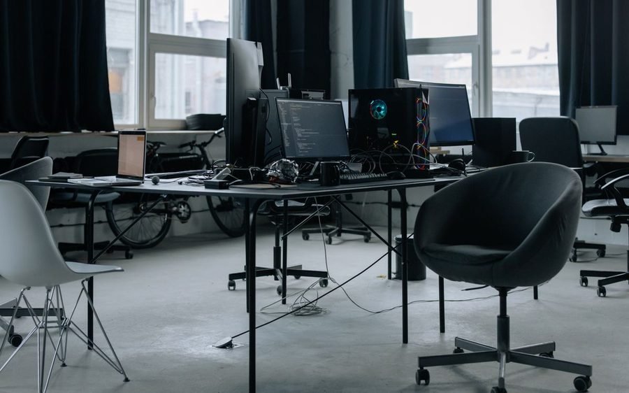 Empty modern office workspace with desks set up for a development team