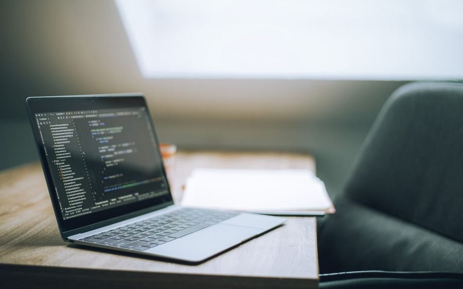 Laptop on a desk showing application source code